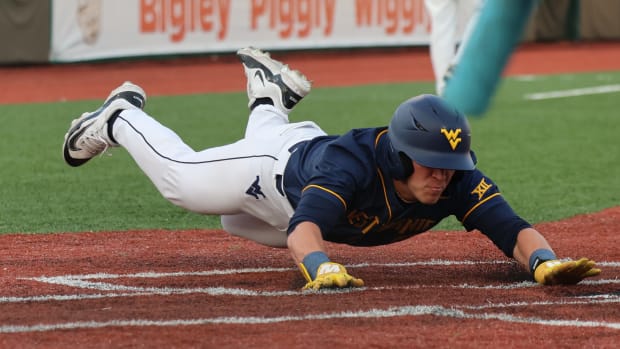 Freshman Spencer Barnett slides into home in the Mountaineers win against Marshall.